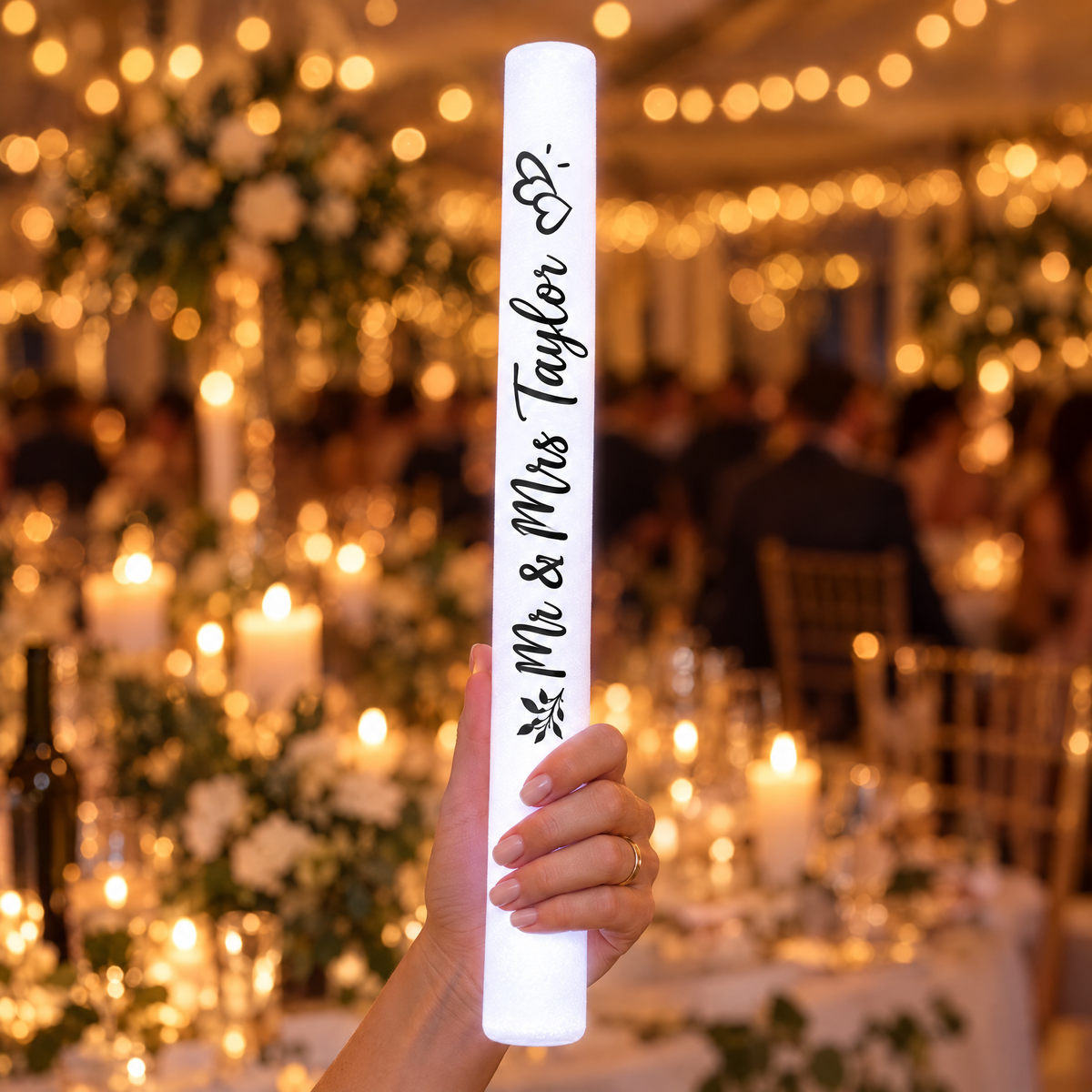 Hand holding a personalised white LED glow stick printed Mr & Mrs Taylor, 35 cm long