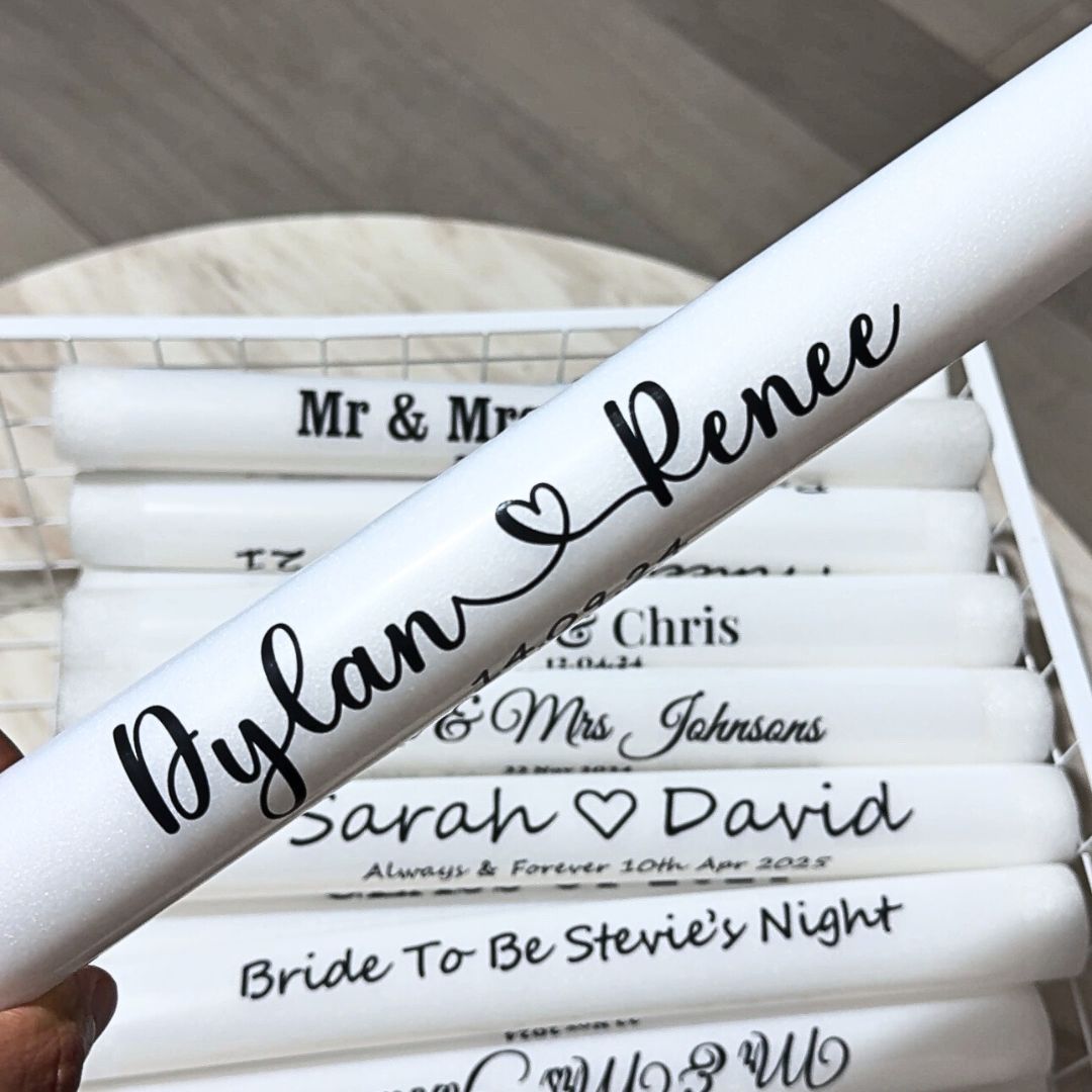 Custom wedding glow sticks with heart design, glowing brightly at a romantic reception party