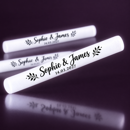 Personalised white LED glow sticks printed with names and date along the stick
