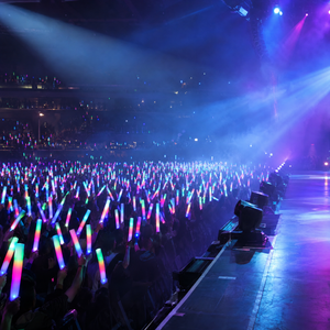 View from the stage over an audience holding LED glow sticks